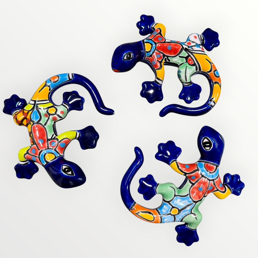 Three colorful ceramic lizards on a white background