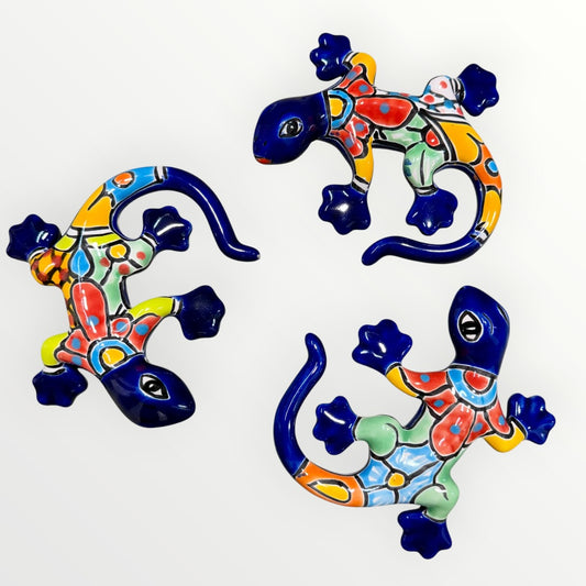Three colorful ceramic lizards on a white background