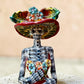 Mexican catrina talavera doll with calla lilies on the front of her dress. wearing a colorful dress with a big feathered hat.   Close up of the face.
