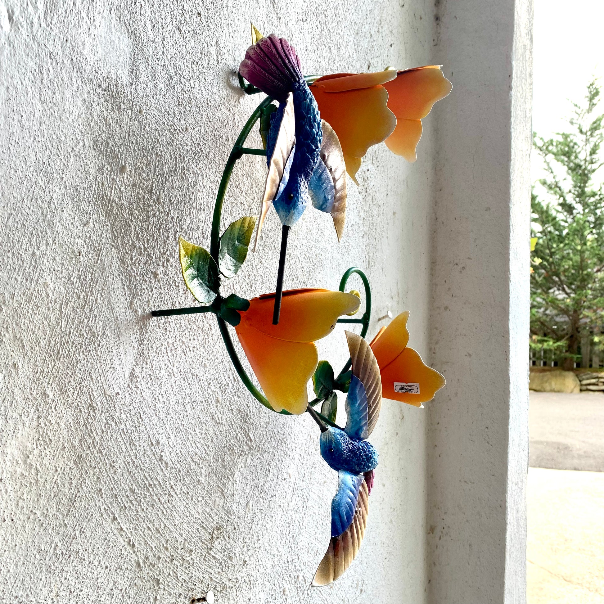 Hummingbirds with yellow flowers sculpture